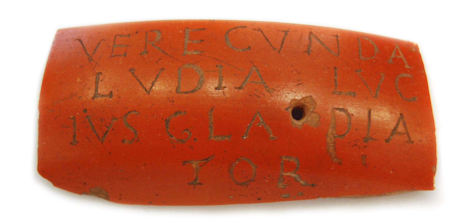A sherd of red-slip Roman pottery with the inscription VERECVNDA LVDIA LVCIVS GLADIATOR meaning ‘Verecunda the actress (or female gladiator) and Lucius the Gladiator’. Possibly a love token meant to be worn -