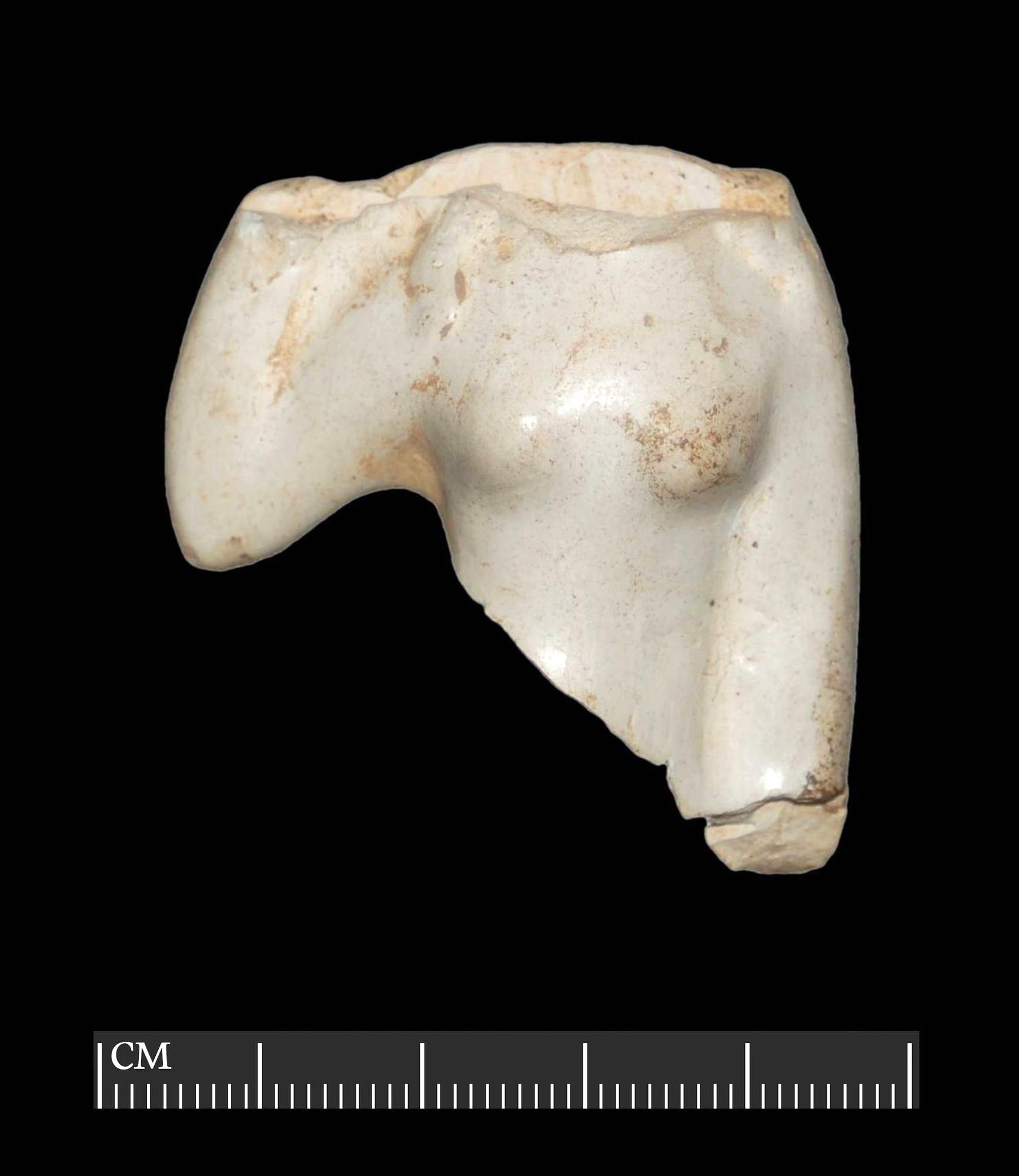The broken torso of a small white-clay votive figurine depicting the Roman goddess Venus. Figurines like this were presented as offerings to the gods at temples or kept in household shrines. They were particularly associated with women during childbirth. Found at Vine Street - University of Leicester Archaeological Services