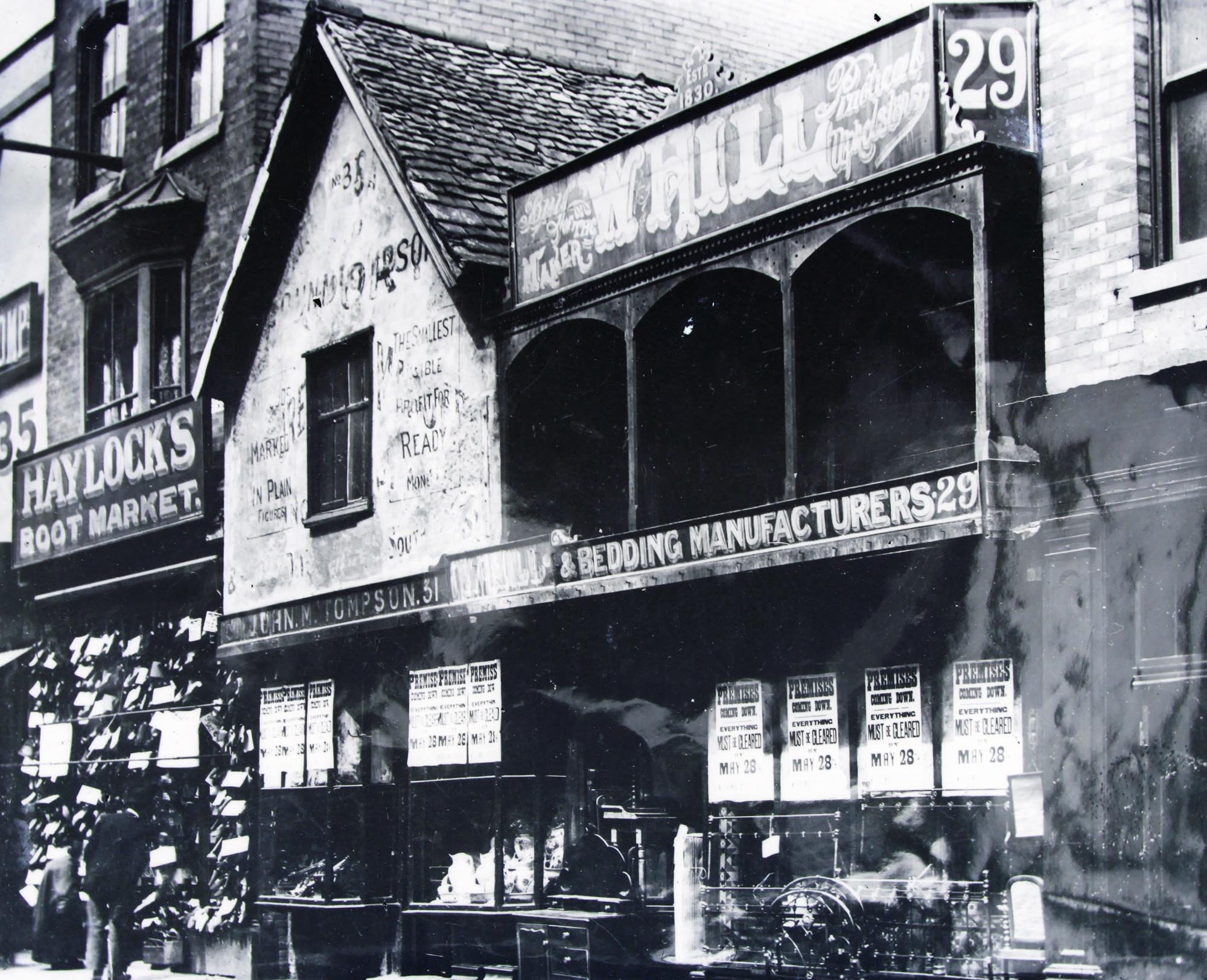 High Street shops, notice the ‘Premises Coming Down May 28’ posters in the window, probably due to the widening for the electric trams c.1904 -