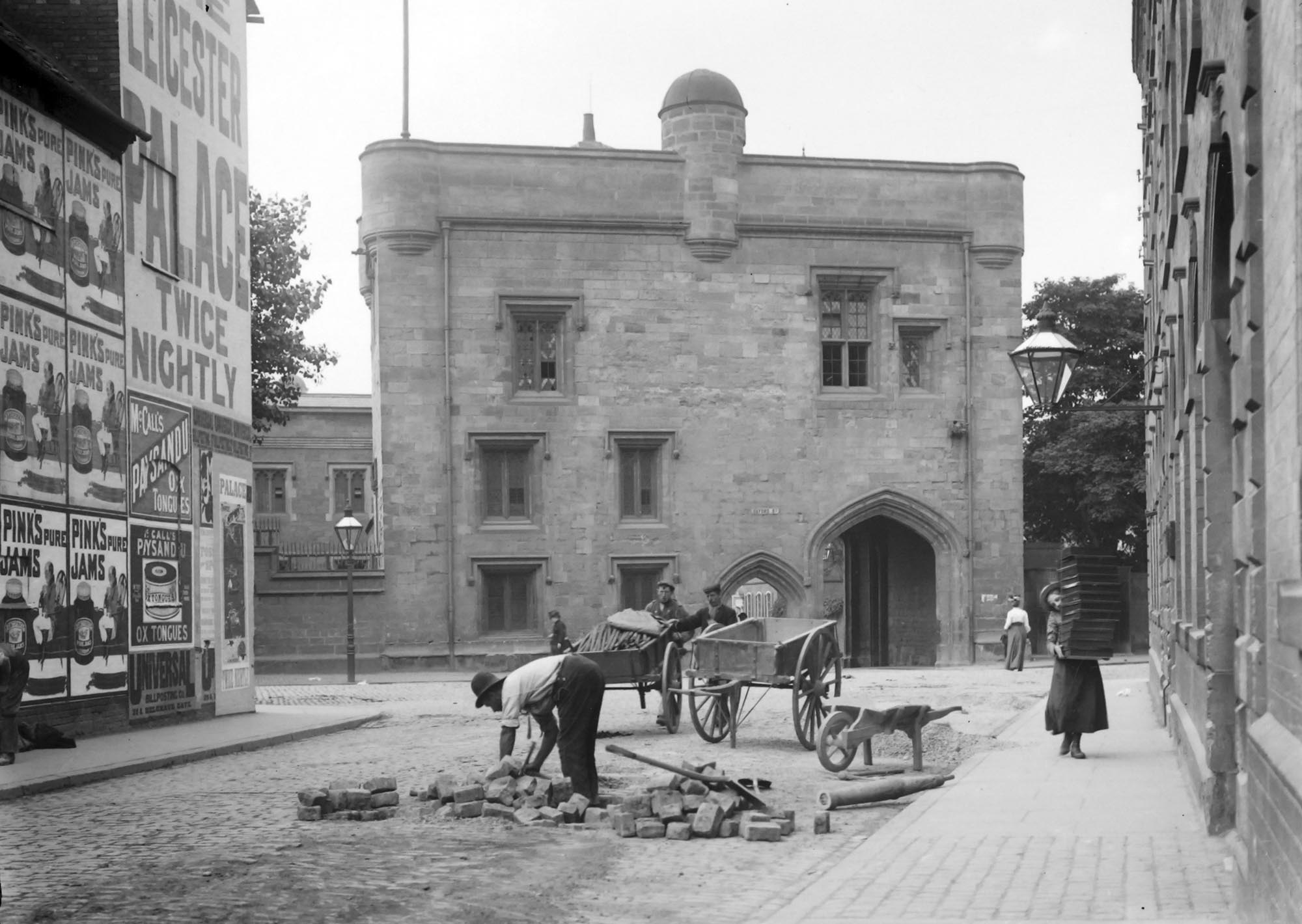 A view of The Magazine looking along Newarke Street with advertisements on the left, circa 1910s - Leicestershire Record Office