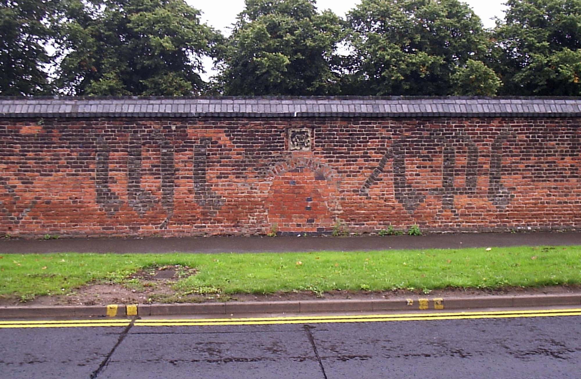 Abbot Penny’s wall (c.1500), showing the ‘mr’ and ‘ihc’ symbols in flared headers. This view can be seen from the road on St. Margaret's Way - 