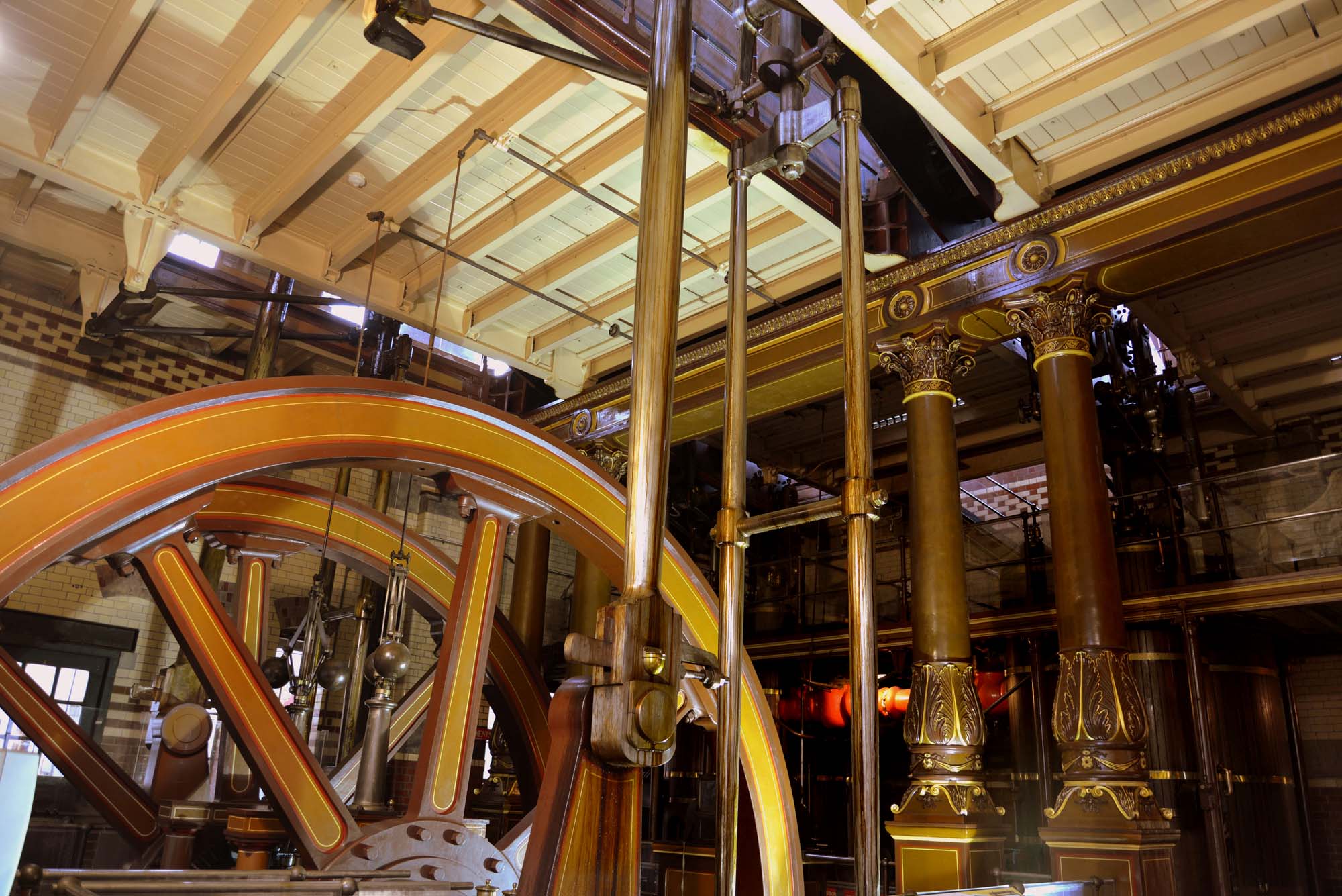 One of the large flywheels and the ornate ironwork of the beam engines -