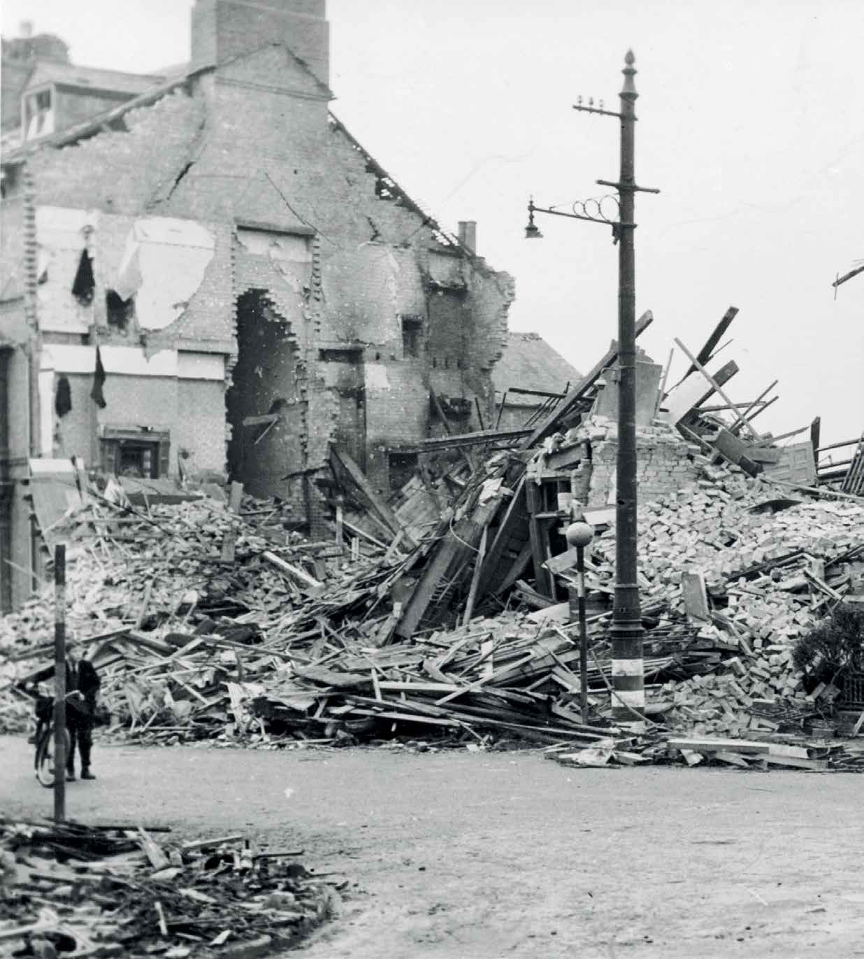 The bombed corner of Saxby Street and Sparkenhoe Street, now Mann Motors. - 