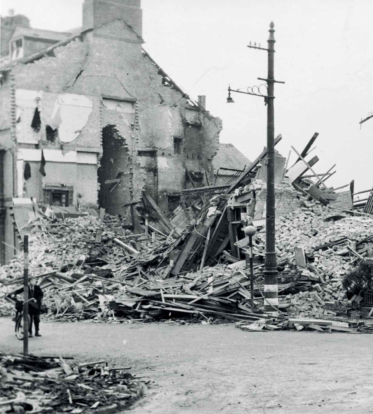 The bombed corner of Saxby Street and Sparkenhoe Street, now Mann Motors. - 