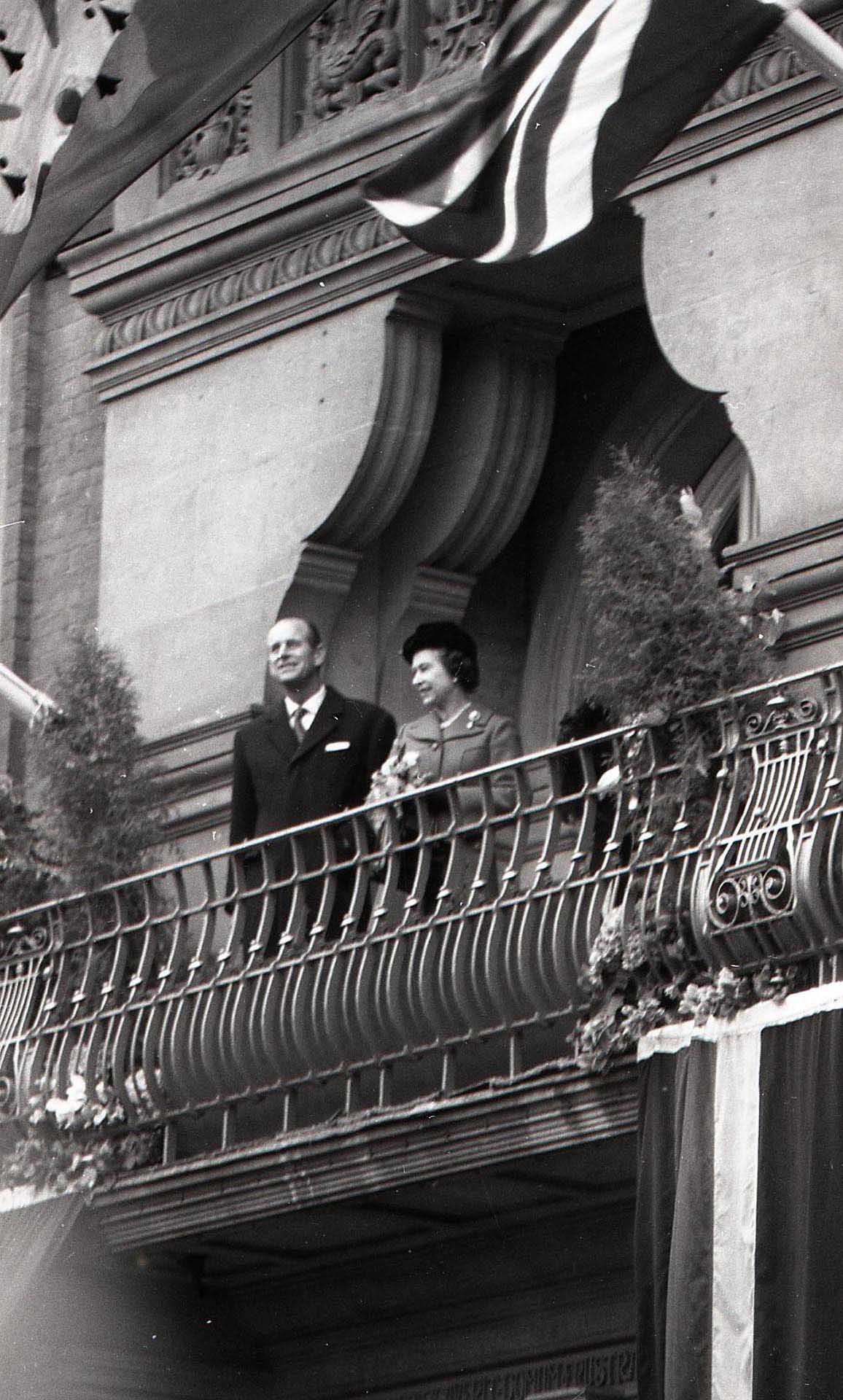 Queen Elizabeth II and Prince Philip greet crows from the balcony of the Town Hall, 1980 - 